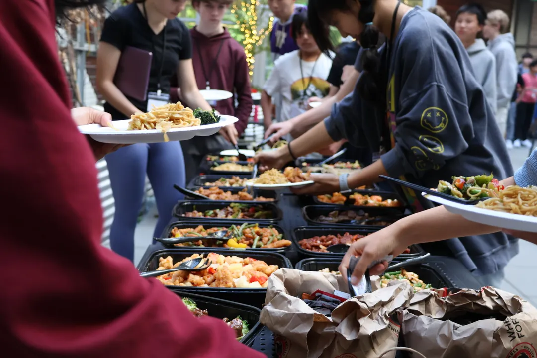 Attendees filling up their plates with complimentary food